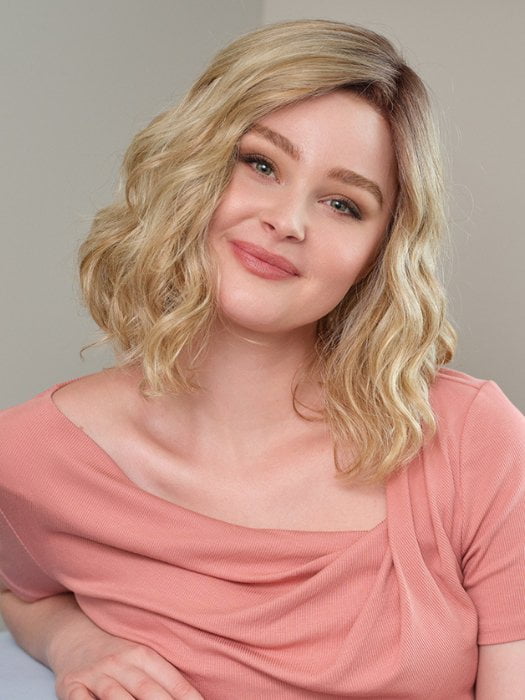 Model wearing EMMA by ENVY in SPARKLING-CHAMPAGNE | Medium Brown roots with overall Strawberry Blonde base and soft Golden Blonde highlights
