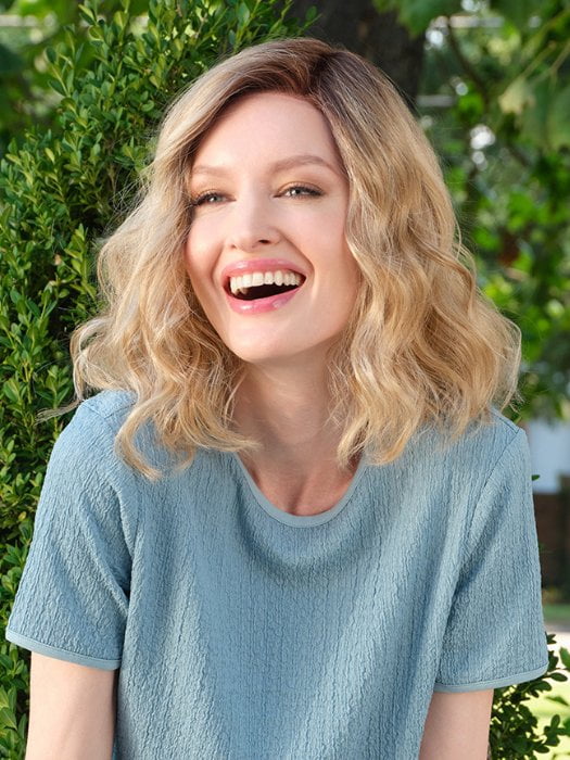 Model wearing EMMA by ENVY in SPARKLING-CHAMPAGNE | Medium Brown roots with overall Strawberry Blonde base and soft Golden Blonde highlights
