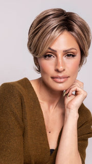Roxie is wearing POSH PREMIERE by RAQUEL WELCH in RL12/22SS SHADED CAPPUCCINO | Light Golden Brown Evenly Blended with Cool Platinum Blonde Highlights with Dark Roots