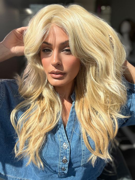 Roxie is wearing California Beach Waves by TressAllure in shade 223/23C | Light Golden Blonde