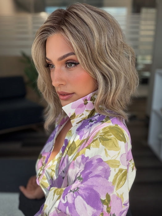 Roxie is wearing VERONICA by BELLETRESS in SPARKLING CHAMPAGNE BLONDE R | A radiant blend of champagne blonde with soft golden and beige tones, grounded by natural-looking roots in ash brown and dark blonde.