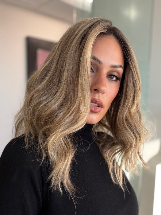 Model is wearing COREY by ENVY in color HONEY BREEZE | A blend of Cool, Honey Blonde and Multi-Dimensional Medium Brown with Darker Brown Roots