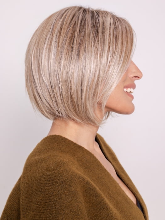 Roxie wearing BECKHAM by BELLETRESS in BUTTERCAKE BLONDE-R | A neutral-warm blonde blend featuring light brown, ash, and lightest blonde tones with natural-looking darker roots for added depth and realism.