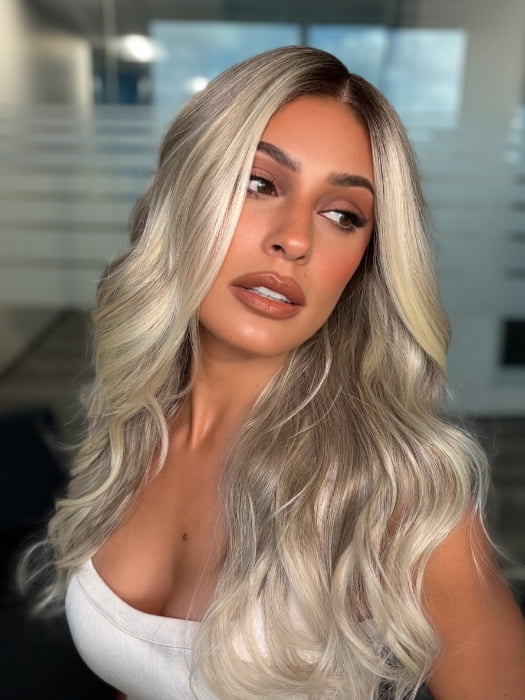 Roxie wearing ESME by RENE OF PARIS in BILLIONAIRE-BLOND | A Rich Mocha Root melting into Beige, Ash, and Cream Blond tones. Face-framing cream and White Blond highlights