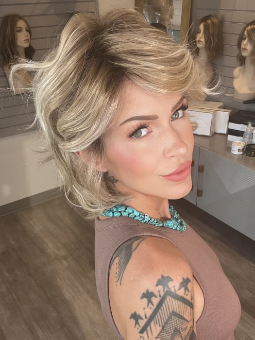 Madeline wearing MONROE by BELLETRESS in BUTTERCAKE BLONDE-R | A neutral-warm blonde blend featuring light brown, ash, and lightest blonde tones with natural-looking darker roots for added depth and realism.