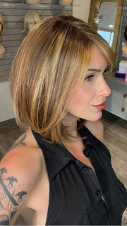 Madeline wearing ROSSI by BELLETRESS in BUTTER PECAN R | A blonde/red blend with a golden-beige base swirled with soft, buttery highlights and light caramel pecan lowlights.