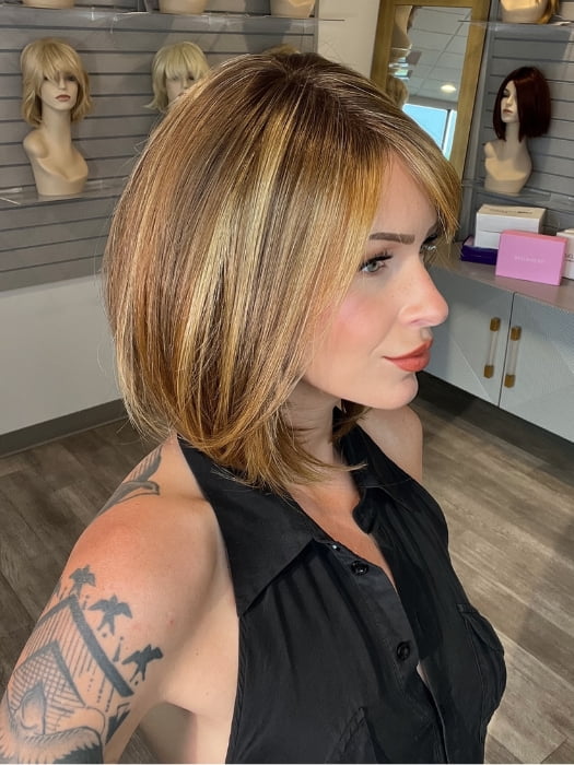 Madeline wearing ROSSI by BELLETRESS in BUTTER PECAN R | A blonde/red blend with a golden-beige base swirled with soft, buttery highlights and light caramel pecan lowlights.