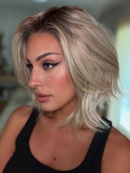 Roxie wearing MIRA by AMORE in SEA SALT BLOND R | A perfect mixture of cool, icy-blond and warm-dark blond. The rich brown root tone enhances the modern appearance.
