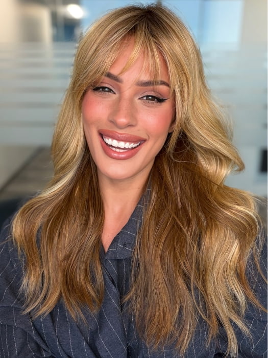Roxie wearing POSH WAVEZ by RENE OF PARIS in Bronzed Honey-R | A perfect blend of rich, warm golden blond and medium chocolate brown tones, complemented by a dark chocolate root that adds a luxurious, dimensional effect.