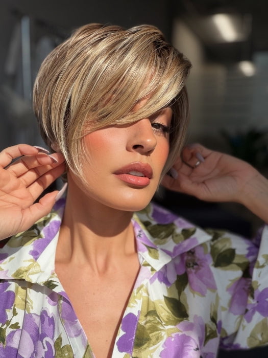 Roxie is wearing POSH PREMIERE by RAQUEL WELCH in RL12/22SS SHADED CAPPUCCINO | Light Golden Brown Evenly Blended with Cool Platinum Blonde Highlights with Dark Roots
