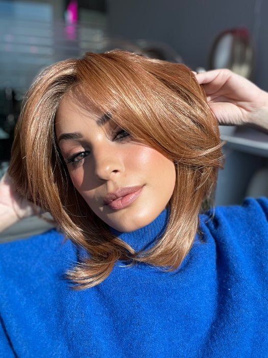 Roxie wearing HUDSON by BELLETRESS in PUMPKIN PIE SPICE-R | Medium brown rooted, combination of strawberry, medium and light copper red, highlighted with light blonde.