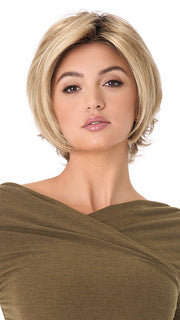 Model is wearing ANGIE by ENVY in color SPARKLING-CHAMPAGNE | Medium Brown roots with overall Strawberry Blonde base and soft Golden Blonde highlights