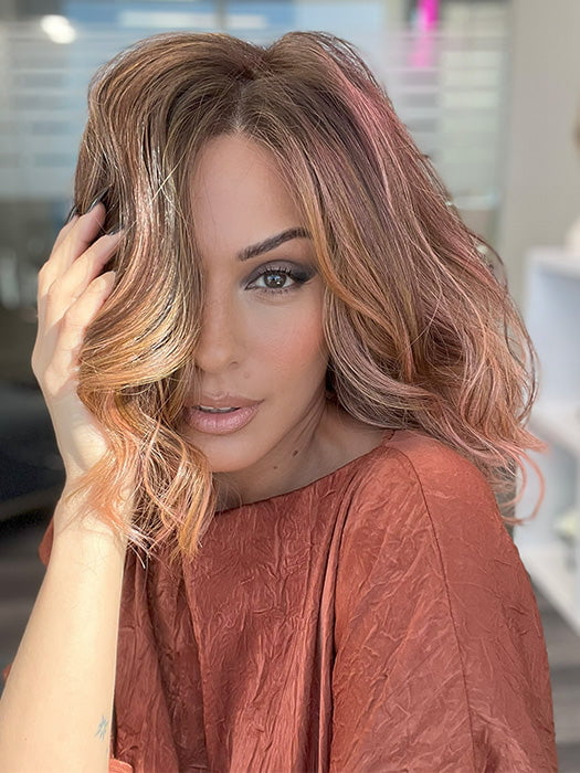 Model is wearing AVALON by ESTETICA in color CINDER HEAT | Reddish brown base blended with smoked copper with soft amber highlights and chestnut brown roots.