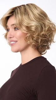 Model is wearing BIANCA by ENVY in color SPARKLING-CHAMPAGNE | Medium Brown roots with overall Strawberry Blonde base and soft Golden Blonde highlights