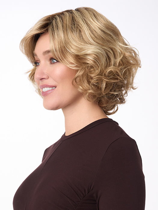Model is wearing BIANCA by ENVY in color SPARKLING-CHAMPAGNE | Medium Brown roots with overall Strawberry Blonde base and soft Golden Blonde highlights