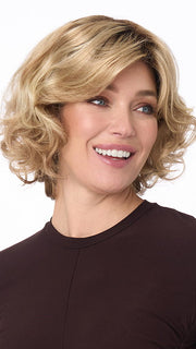 Model is wearing BIANCA by ENVY in color SPARKLING-CHAMPAGNE | Medium Brown roots with overall Strawberry Blonde base and soft Golden Blonde highlights