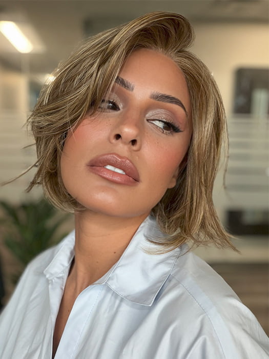 Roxie is wearing CLOVER by ESTETICA in color R12/26CH | Light Brown with Chunky Golden Blonde Highlights