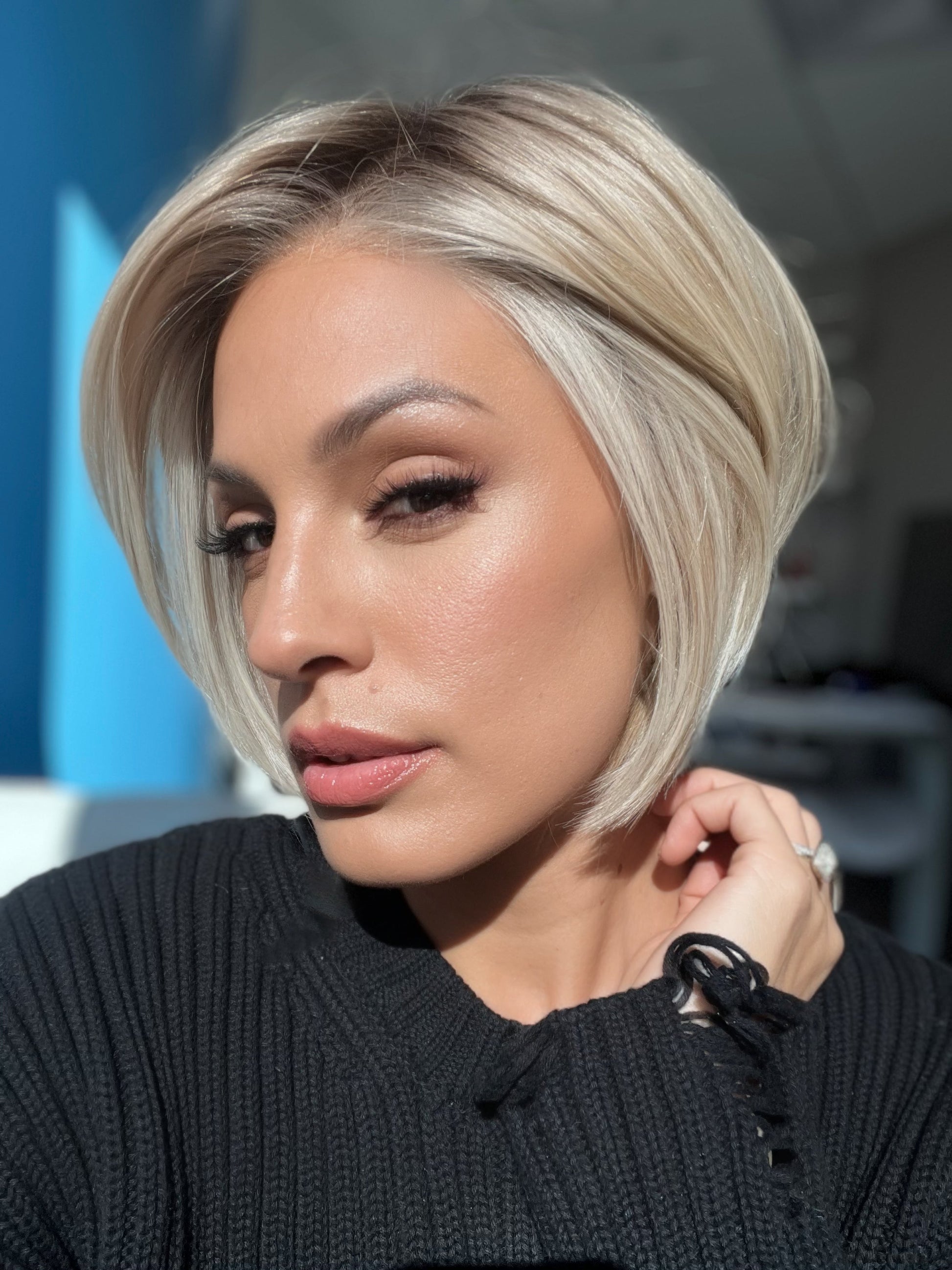 Roxie wearing STRAIGHT UP WITH A TWIST By RAQUEL WELCH in SS19/23 SHADED BISCUIT | Cool Platinum blonde with subtle highlights and medium brown roots