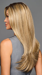 Model is wearing STAY OUT LATE in color GF12-22SS SS CAPPUCCINO | A radiant blend of warm blonde tones with sunlit highlights and soft dimension