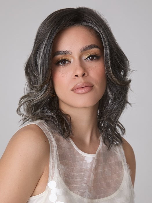 Model is wearing ROHAN by AMORE in color TRUFFLE RIBBON R | Off-Black base with Warm Medium Brown and Silver highlights. The Dark Brown Root creates a naturally dimensional appearance