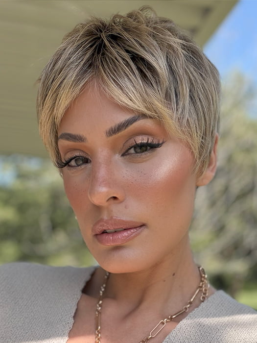 Roxie is wearing IRIS by JON RENAU in color 24BT18S8 SHADED MOCHA | Medium Natural Ash Blonde & Light Natural Gold Blonde Blend, Shaded with Medium Brown
