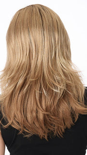 Model is wearing JOY by ENVY in color SPARKLING-CHAMPAGNE | Medium Brown roots with overall Strawberry Blonde base and soft Golden Blonde highlights