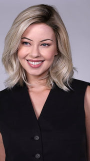 Model is wearing MANHATTAN by BELLETRESS in color CRUSHED-ALMOND-BLONDE-R | A soft Neutral Light Blonde with a Light and Medium Blended Root Color