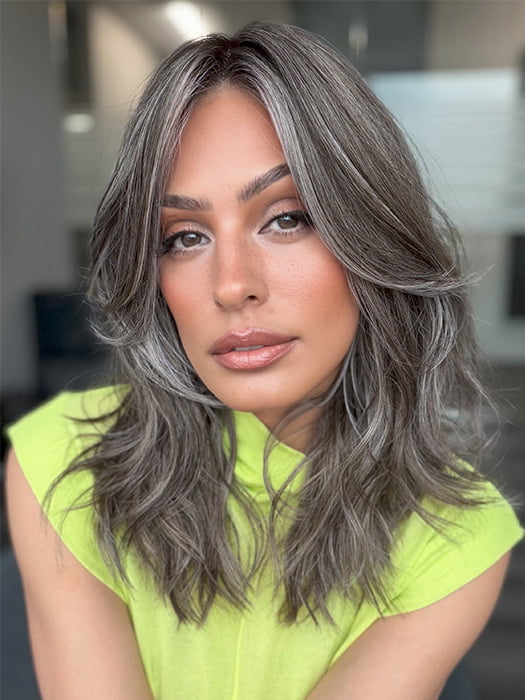 Model is wearing MAUDE by AMORE in color MUSHROOM-GREY-R | Dark brown incorporates light brown and silvery grey tones with shadow roots for a stylish finish.