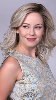 Model is wearing MORGAN By BELLETRESS in CRUSHED-ALMOND-BLONDE-R | A Soft Neutral Light Blonde with a Light and Medium Blended Root Color