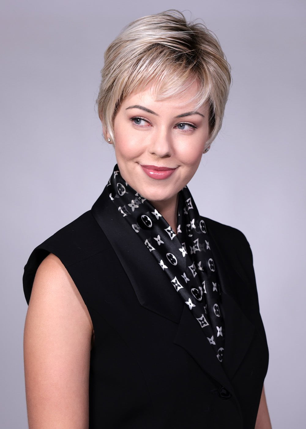 Model is wearing Gramercy in CRUSHED ALMOND BLONDE R | A soft Neutral Light Blonde with a Light and Medium Blended Root Color