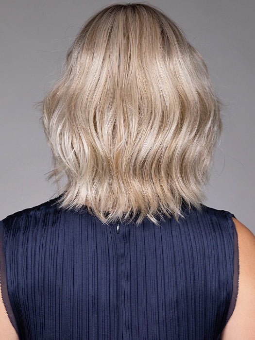 Model is wearing OLIVIA in color BUTTERBEER R | Dark Brown Base and Root that transitions smoothly into a buttery blonde, infused with creamy honey and toffee tones