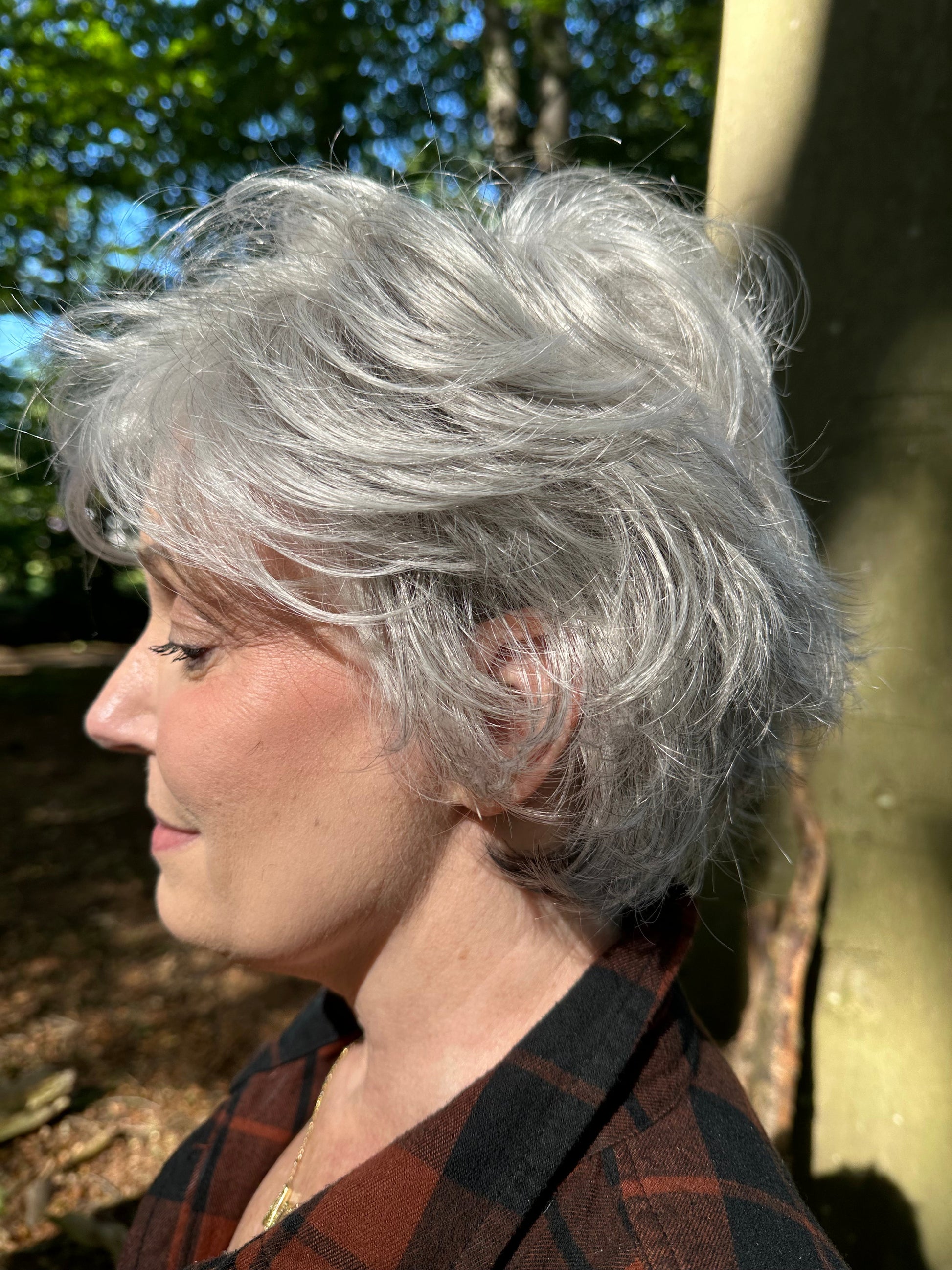Mel B. @mels.be.ageless wearing VOLTAGE LARGE by RAQUEL WELCH WIGS in color RL51/61 ICED GRANITA | Lightest Grey Progresses to a Deep Grey at the Nape
