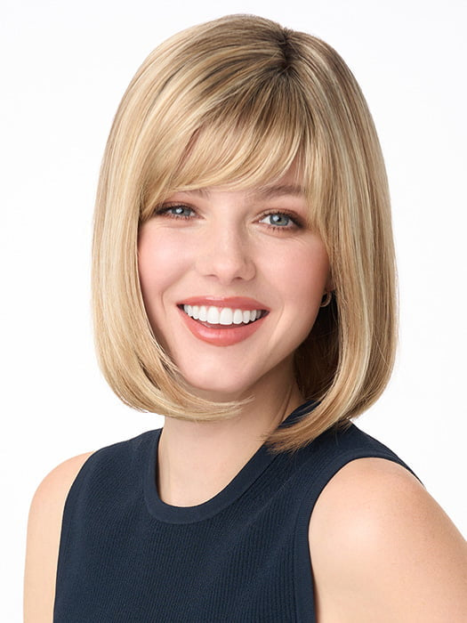 Model is wearing PAIGE PETITE by ENVY in color SPARKLING CHAMPAGNE | Medium Brown roots with overall Strawberry Blonde base and soft Golden Blonde highlights