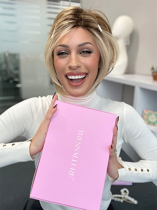 Model wearing POISED by TRESSALLURE in color EL12/22/R8 | Light Golden Brown Evenly Blended with Platinum Blonde Highlights with Medium Brown Roots (styled; clips not included)