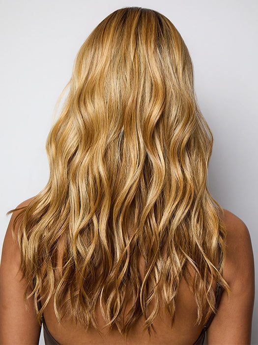 Model is wearing POSH WAVEZ in Bronzed Honey-R  | A perfect blend of rich, warm golden blond and medium chocolate brown tones, complemented by a dark chocolate root that adds a luxurious, dimensional effect.