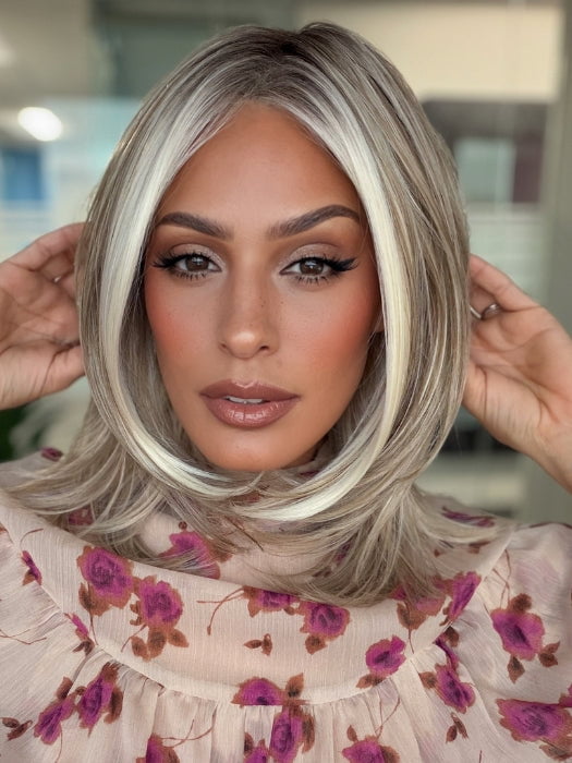 Roxie is wearing DREW by JON RENAU in 101/88/27S8 CATALINA BLONDE | Pale blonde with Pure White Natural Violet halo highlights, shaded medium brown