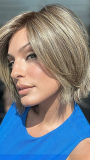 Model is wearing READY by ELLEN WILLE in color BERNSTEIN ROOTED 12.24.27 | Light Brown base with subtle Light Honey Blonde and Light Butterscotch Blonde highlights and Dark Roots