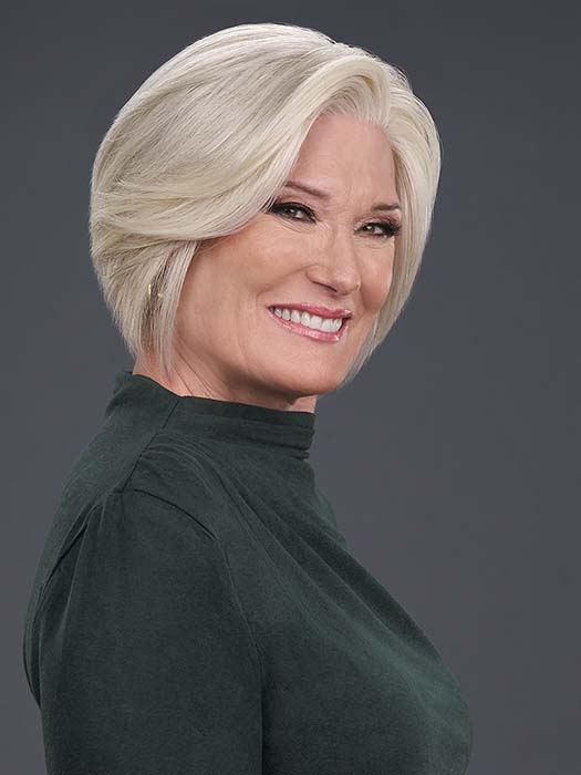 Model is wearing IGNITE HH in color 56F51 OYSTER | Light Grey with 20% Medium Brown Front, graduating to Grey with 30% Medium Brown Nape