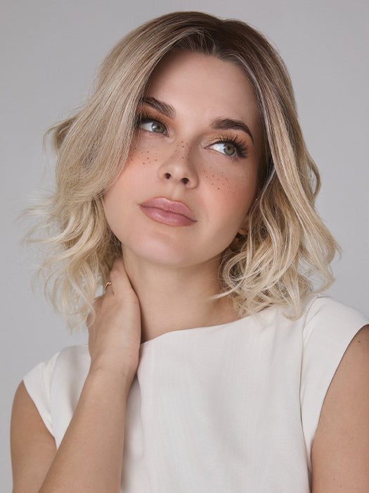 Model is wearing ROHAN by AMORE in color MELTED SAND |  Rich, warm brown root melts into the neutral blond tone. Light-beige blond ends complete this stunning color.  