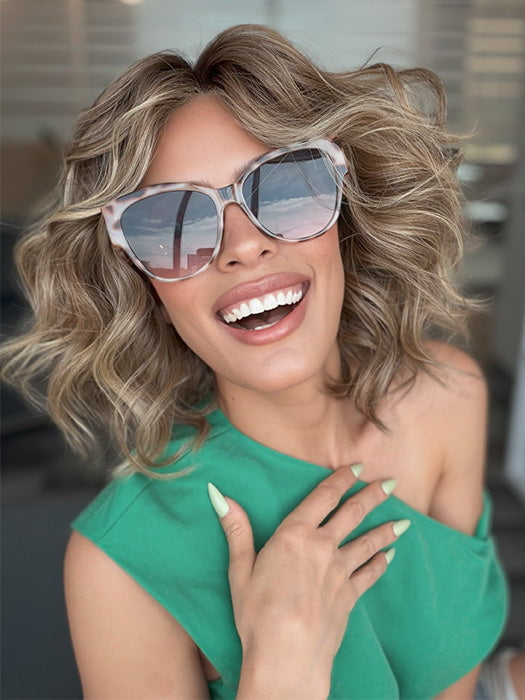 Model is wearing ROMANTIC RENAISSANCE by RAQUEL WELCH in color SS12/22 SHADED CAPPUCCINO | Light Golden Brown Evenly Blended with Cool Platinum Blonde Highlights and Dark Roots