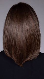 Model is wearing STREISAND in SOFT AMBER BROWN R | A warm rooted, amber-toned shade blending golden and red hues over a medium brown base.