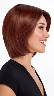 Model is wearing SHEER JOY by TRESSALLURE in color 33/130/R4 | Dark Auburn Bright Auburn Blend Rooted Dark Brown