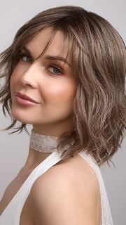 Terra by Amore in color BRONDE-R | Dark brown and natural medium blond tones are mixed together and shaded with medium dark brown roots for a realistic appearance.