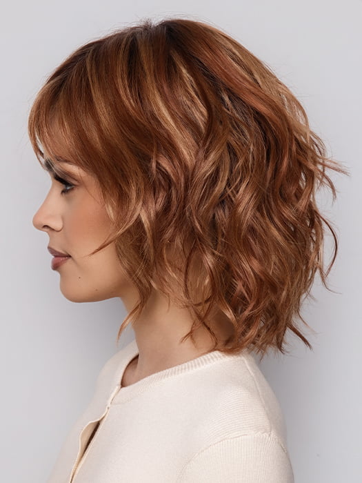 Terra by Amore in color RUSTY-SUNRISE-R | Dark brown roots transition into a deep auburn tone with light copper blonde highlights for depth and dimension.