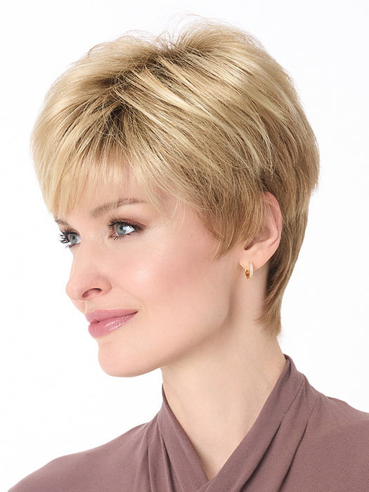 Model is wearing TIFFANY by ENVY in color SPARKLING CHAMPAGNE | Medium Brown roots with overall Strawberry Blonde base and soft Golden Blonde highlights