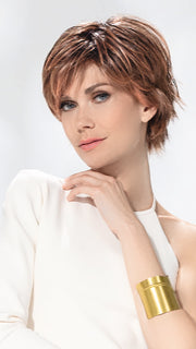 Model is wearing AVENUE SOFT by ELLEN WILLE in color ROSEWOOD LIGHTED | Medium Brown, Caramel, and Rose Gold blend with Highlights Throughout and Concentrated in the Front with Shaded Roots