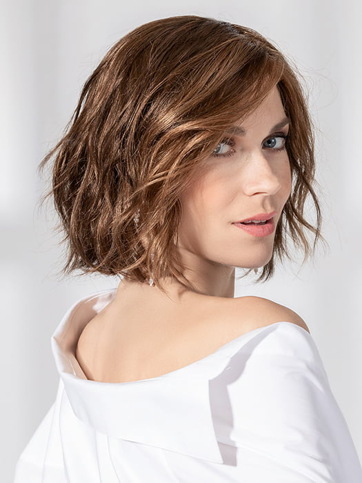 Model is wearing ESPRIT SOFT SMALL by ELLEN WILLE in color CHOCOLATE LIGHTED 830.6.27 | Dark and Medium Brown Blended with Light Auburn Brown and Dark Strawberry Blonde with Highlights Throughout and Concentrated in the Front