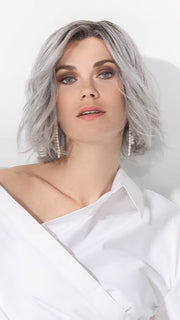 Model is wearing ESPRIT SOFT SMALL by ELLEN WILLE in color METALLIC GREY ROOTED 60.51 |  Pearl White, Darkest/Lightest Brown with Grey Blend with Shaded Roots