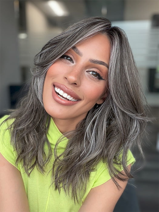 Model is wearing MAUDE by AMORE in color MUSHROOM-GREY-R |  Dark brown incorporates light brown and silvery grey tones with shadow roots for a stylish finish.