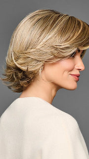 Model is wearing STAND OUT STYLE by GABOR in color GF12-22SS SHADED CAPPUCCINO | Light Golden Brown Evenly Blended with Cool Platinum Blonde Highlights with Dark Roots